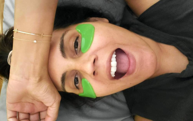 Best vegan skincare brands: Mar wearing 100% Pure's green eye masks
